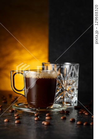 Espresso, glass of cold water, and roasted coffee beans. Espresso, glass of cold water, and roasted coffee beans. 129688320