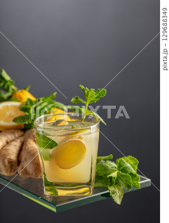Refreshing summer cocktail with ice, ginger, lemon, and mint. Refreshing summer cocktail with ice, ginger, lemon, and mint. 129688349