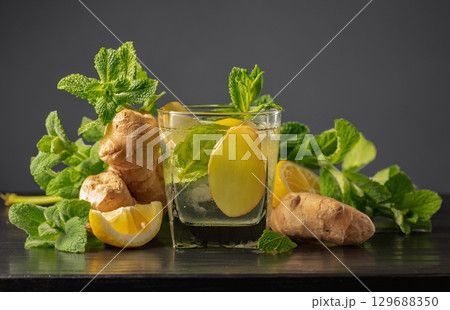Cold refreshing drink with ice, ginger, lemon, and mint. Cold refreshing drink with ice, ginger, lemon, and mint. 129688350