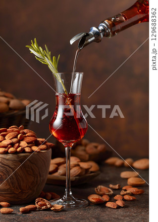 Italian liqueur Amaretto with almonds nuts. 129688362