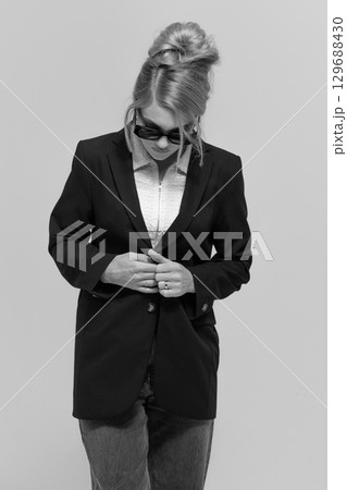 Beautiful woman with black suit and sunglasses black and white studio portrait portrait Beautiful woman with black suit and sunglasses black and white studio portrait portrait 129688430