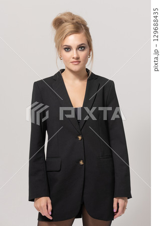 Beautiful woman with black suit studio portrait portrait on white background Beautiful woman with black suit studio portrait portrait on white background 129688435