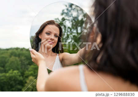 Woman Reflecting in Nature Woman Reflecting in Nature 129688830