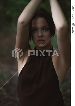 Mysterious Woman in Forest Setting Mysterious Woman in Forest Setting 129688840
