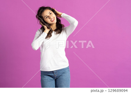 Beautiful woman listening music with headphones Beautiful woman listening music with headphones 129689094