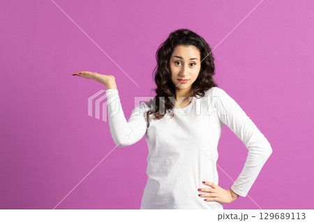 Beautiful woman holding one arm raised Beautiful woman holding one arm raised 129689113