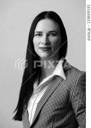 Business woman with black and white suit studio portrait 129689191