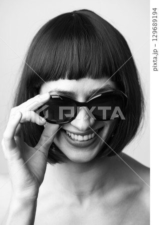 Close-up portrait of beautiful woman with wig and sunglasses Close-up portrait of beautiful woman with wig and sunglasses 129689194