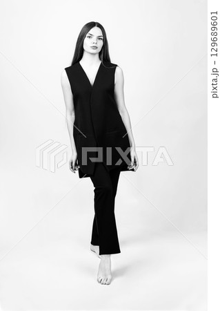 Beautiful woman with black suit studio portrait Beautiful woman with black suit studio portrait 129689601