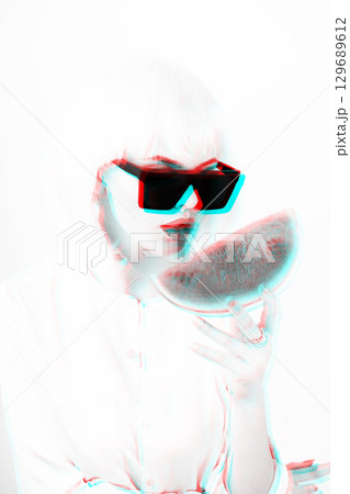 Woman with white wig holding slice of watermelon in rgb color split effect 129689612