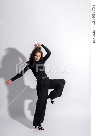 Woman with black outfit studio portrait on white background with copy space 129689755