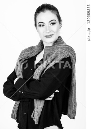 Studio portrait of beautiful woman with purple sweater on her shoulders Studio portrait of beautiful woman with purple sweater on her shoulders 129689888