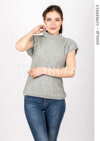 Close-up shot of woman wearing gray sweater without sleeves 129689913