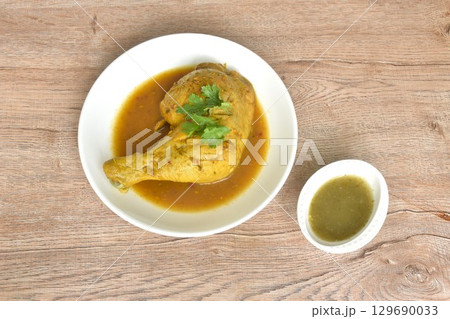 baking chicken tight and leg with herb on plate dipping spicy and sour chili sauce in cup baking chicken tight and leg with herb on plate dipping spicy and sour chili sauce in cup 129690033