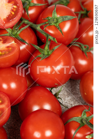 Lots of ripe fresh cocktail tomatoes close-up. 129690697