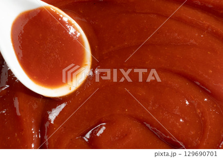 Traditional Ketchup in Spoon Macro. Organic Culinary Element. 129690701