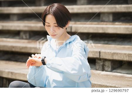 スポーツウォッチを確認する若い女性　スポーツイメージ 129690797