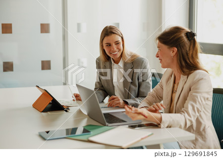 Businesswomen Collaborating Together in a Modern Office Environment to Foster Growth and Success Businesswomen Collaborating Together in a Modern Office Environment to Foster Growth and Success 129691845