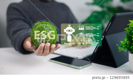 Hand holding ESG symbol with AI agent icons on tablet, representing sustainability, corporate governance, environmental responsibility, and digital technology integration. 129693895