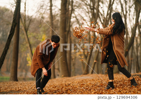 Young couple in love walking in the park on a autumn day. Enjoying time together. 129694306