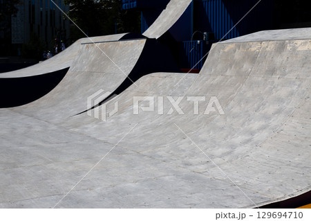 Street ramps for performing tricks on skateboard or bike. Equipment for extreme pastime. Ramp for jumping and stunt. Getting adrenaline and new emotions on street ramp Street ramps for performing tricks on skateboard or bike. Equipment for extreme pastime. Ramp for jumping and stunt. Getting adrenaline and new emotions on street ramp 129694710