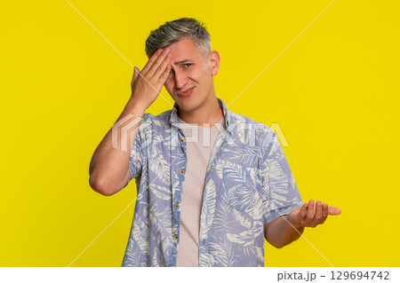 Adult man showing facepalm with tired disappointed expression symbolizing failure stress frustration Adult man showing facepalm with tired disappointed expression symbolizing failure stress frustration 129694742
