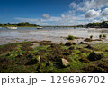 River Deben at low tide with small boats on a sunny day. View near the historic town of Woodbridge in Suffolk, UK. 129696702