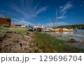 Boats on a sunny day at the quay in the historic town of Woodbridge in Suffolk, UK. View at low tide on the River Deben. 129696704
