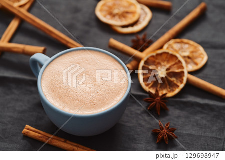 Hot chocolate in a blue cup with natural christmas decorations 129698947