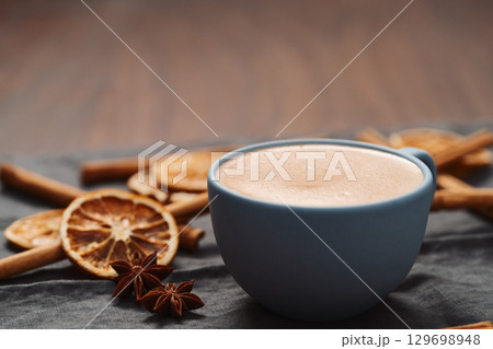 Hot chocolate in a blue cup with natural christmas decorations Hot chocolate in a blue cup with natural christmas decorations 129698948