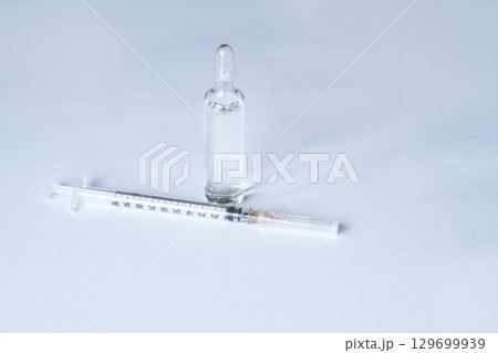Medical syringe and ampoule on white background for healthcare and medical 129699939