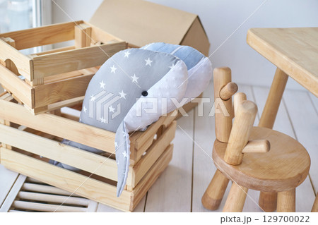 Cozy child s room with wooden furniture and plush starry whale toy in crate Cozy child s room with wooden furniture and plush starry whale toy in crate 129700022