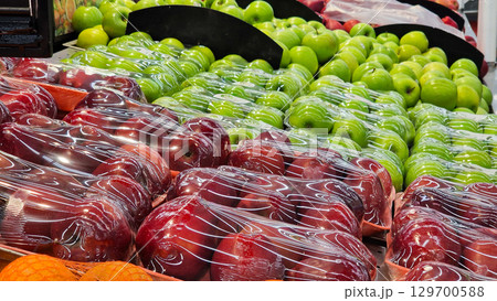 An abundant pile of fresh fruits on a market stall. Eco food, vegetarian lifestyle, organic nutrition, and healthy eating. 129700588