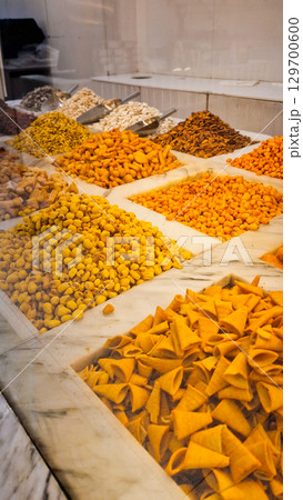 A variety of nuts and dried fruits displayed on a market stall.  Eco food, vegetarian diet, organic snacks, and healthy natural nutrition. 129700600