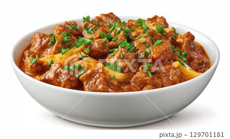 Delicious Pork Curry with Fresh Herbs and Rich Sauce in a White Bowl Perfect for Comfort Food Lovers 129701181