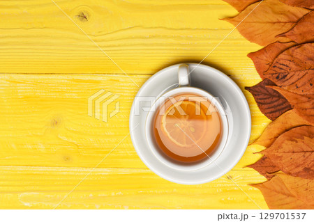 Tea cup with dry leaves making autumn composition 129701537