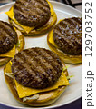 Delicious homemade cheeseburgers with grilled patties on fresh buns served on a plate 129703752