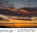 Stunning sunset over the horizon with vibrant colors reflecting on the clouds 129703767