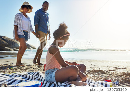 Fun, relax and girl at the beach with parents for holiday, summer and travel in Portugal. Freedom, playful and black family at the ocean for a vacation, fresh air and coastal trip at the sea Fun, relax and girl at the beach with parents for holiday, summer and travel in Portugal. Freedom, playful and black family at the ocean for a vacation, fresh air and coastal trip at the sea 129705360