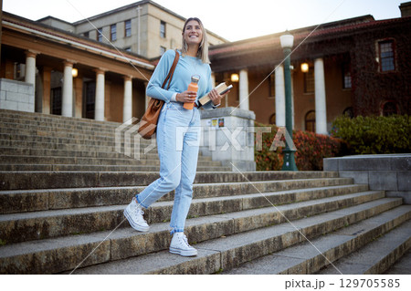Woman, student on campus stairs and university, education with learning and academic goals with scholarship outdoor. Books for reading, study and happy person with success, college life and studying Woman, student on campus stairs and university, education with learning and academic goals with scholarship outdoor. Books for reading, study and happy person with success, college life and studying 129705585