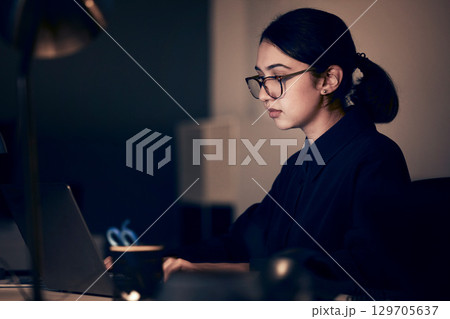 Woman, night office and laptop for business, coding and strategy in dark startup company. Female working overtime online with technology on website, computer programmer and search internet analytics 129705637