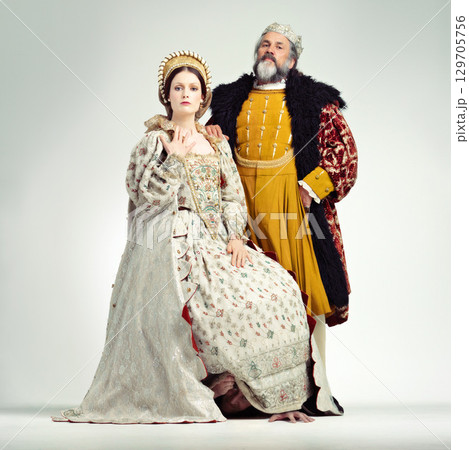 Fashion, medieval and king with queen on a white background for power, leaders and ruler. History, theatre and royal couple portrait in vintage, renaissance and Victorian cosplay isolated in studio Fashion, medieval and king with queen on a white background for power, leaders and ruler. History, theatre and royal couple portrait in vintage, renaissance and Victorian cosplay isolated in studio 129705756