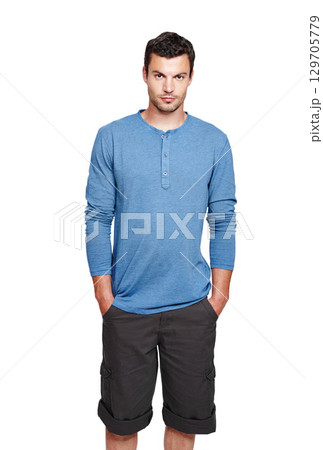 Man, studio portrait and casual fashion with serious face, style and focus by white background. Young isolated model, shorts and clothes with calm, relax or handsome with cool confidence in lifestyle Man, studio portrait and casual fashion with serious face, style and focus by white background. Young isolated model, shorts and clothes with calm, relax or handsome with cool confidence in lifestyle 129705779