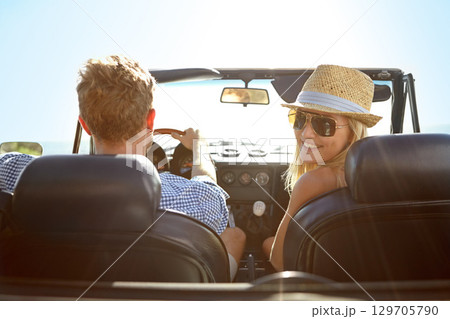 Car travel, road trip and back portrait of couple on bonding holiday adventure, transportation journey or fun summer vacation. Love flare, convertible vehicle or driver driving in Ukraine countryside 129705790