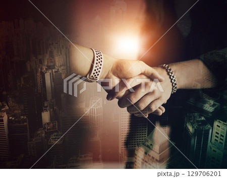 Business people, handshake and agreement with city overlay for partnership, teamwork and welcome. Corporate women, shaking hands and thank you for commitment, goals and deal with hologram of metro 129706201