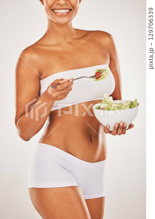 Salad, happy and body of woman isolated on a white background diet, lose weight and healthy food promotion. Green vegetables, fitness and model person in underwear for detox beauty in studio mockup 129706339