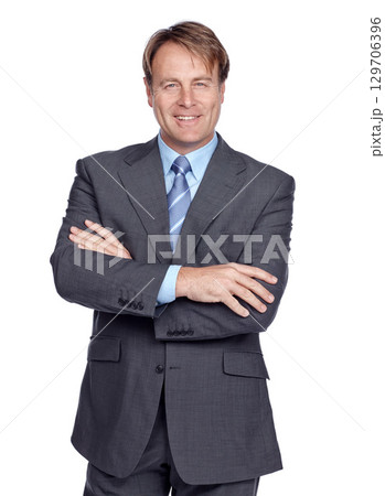 Businessman, studio portrait and suit with arms crossed, smile or leadership success by white background. Happy corporate leader, focus and isolated for executive goal, mission or professional vision 129706396