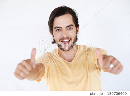 Thumbs up, success and portrait of man in white background, studio or isolated emoji. Male model, thumb up and support of yes agreement, celebration and hand sign, vote or trust, thank you and winner Thumbs up, success and portrait of man in white background, studio or isolated emoji. Male model, thumb up and support of yes agreement, celebration and hand sign, vote or trust, thank you and winner 129706400