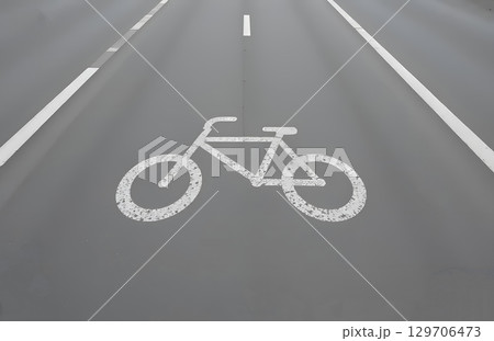 Bicycle Symbol Marking on Asphalt Road Indicating Dedicated Cycling Path. 129706473