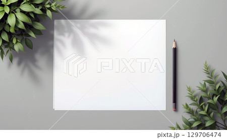 Blank Paper and Pencil with Green Leaves on Desk. 129706474